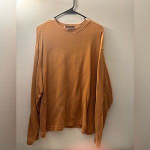 A nice orange sweater that is perfect for spring or fall